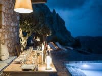 Torre di Mani-Mani-Peninsula-by-Olive-Villa-Rentals-night-exterior-dining-area