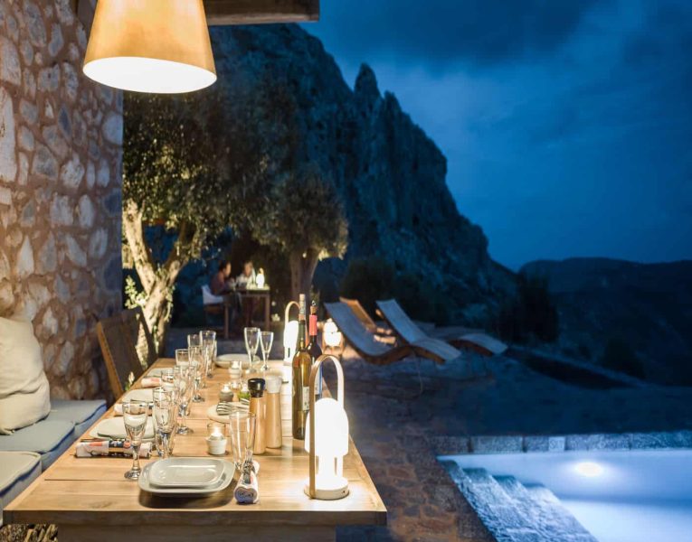 Torre di Mani-Mani-Peninsula-by-Olive-Villa-Rentals-night-exterior-dining-area