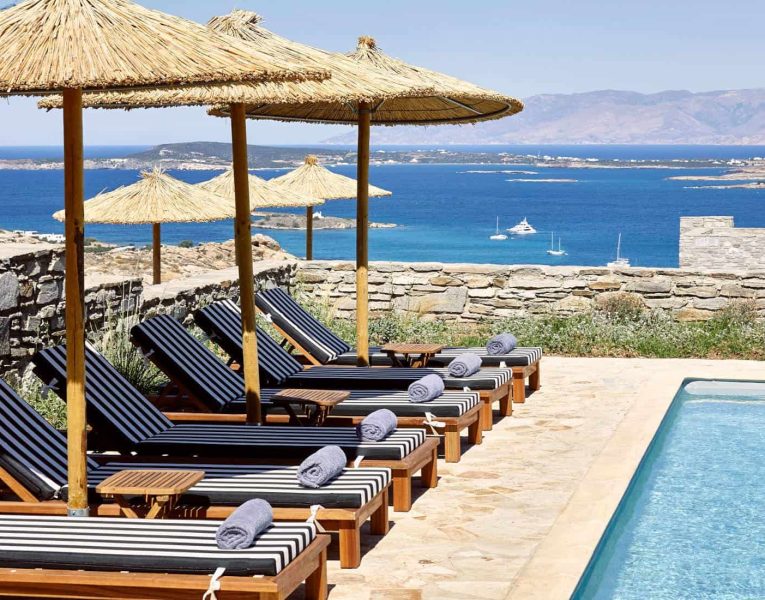 Villa- Cinqo-Paros-by-Olive-Villa-Rentals-exterior-pool-area-sunbeds