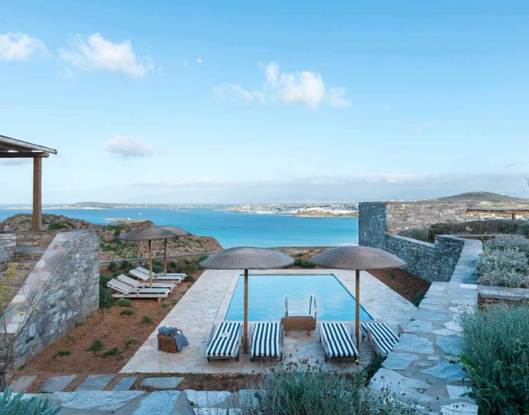 Villa- Cinqo-Paros-by-Olive-Villa-Rentals-exterior-pool-area-sunbeds